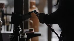 A blacksmith blasts heat onto metal held in place with a vice with a blowtorch. Stock Footage