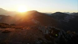 Man on the top of a mountain aerial Stock Footage