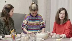 Students looking at teacher rolling clay in studio Stock Footage