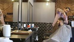 Male customer discussing haircut with hairdresser Stock Footage