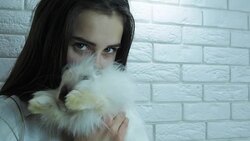 Beautiful girl with a white rabbit. Stock Footage
