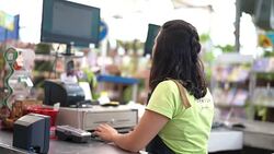 Portrait of confident owner leaning on checkout counter at flower shop Stock Footage