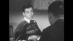 BOY SITS AT TABLE, IN CHRISTMAS JUMPER HOLDS PEN. Stock Footage
