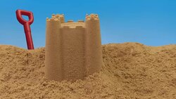 Passing Sand Castle On Beach Stock Footage