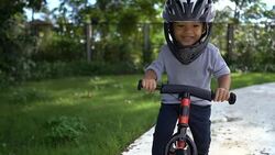 SLO MO Toddler riding balance bike. Stock Footage