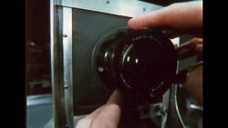UNITED STATES 1960s: Man points / Man adjusts model on set. Stock Footage