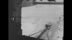 Parachuting packages out of cargo bay door of C-119 during the Korean War; pilots News Clip