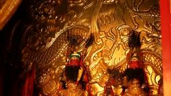 Buddhist traditional statues of chinese sacred gods on the altar inside the temple Stock Footage