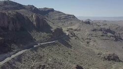 Aerial Drone Shot of Car Travelling on Desert Road Stock Footage