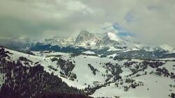 Flying on Seiser Alm with Langkofel mountain in background Stock Footage