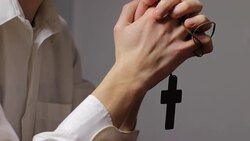 Man Praying with a Cross in Hands Stock Footage