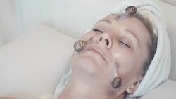 application of slime snails in alternative medicine and beauty industry for anti-aging skin care of the face Stock Footage