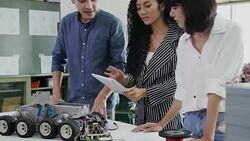 Teenage works on a fully functional programable Robot for robotics club project.Creative designer testing robotics prototype in workshop.Science concept Stock Footage