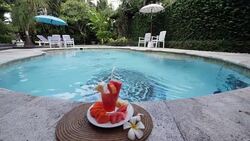 Healthy fruit drinking on a table in an spa resort with pool in Bali Stock Footage