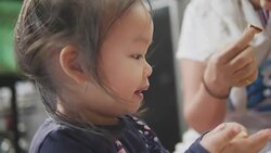 Happy Asian baby girl eating food at home. feed by her mom. Concept : Food,Family,life. Stock Footage
