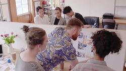 Creative designers discussing photograph proofs in office meeting Stock Footage