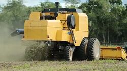 Agricultural tractor harvesting field farm in 4K 60fps Stock Footage