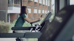 Beautiful woman cycling on the exercise bike in the gym Stock Footage