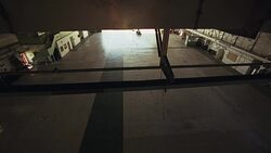 HIGH ANGLE DOWN SHOWS PRIVATE JET  TOWED INTO AIRPLANE HANGAR BY TRACTOR. PLANE IS HAWKER SIDDELEY HS 125-700B. Stock Footage