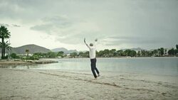 Businessman running away to the beach Stock Footage