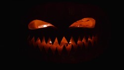 Pumpkin with a carved angry face and teeth. Stock Footage