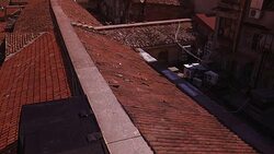 HIGH ANGLE DOWN OF SPANISH TILE ROOFTOPS IN LOWER CLASS RESIDENTIAL AREA. EUROPEAN CITY. Stock Footage