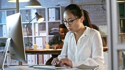 Asian Woman Working Late in Office Stock Footage