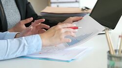 Two office workers analyzing growth graph Stock Footage