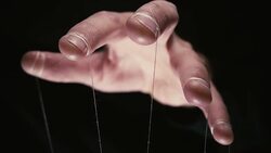 Puppeteer with manipulating hands controlling all your moves. Concept Stock Footage