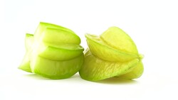 One whole and one half of carambola fruit. Rotating on the turntable isolated on the white background. Close up. Macro. Stock Footage