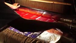 Craftsman working on huge old wooden brocade weaving looms Stock Footage