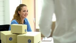 Woman working using laptop check packing list order. Man sent packing box for shipping parcel package at office. Delivery Shopping online. Stock Footage