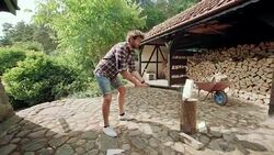 Man splitting logs for firewood Stock Footage