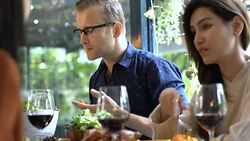 festive celebration party dinner with group of caucasian man and asian woman friends enjoy and happiness conversation with wine food in restaurant background Stock Footage