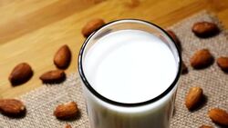 Rotating Almond milk in glass Stock Footage