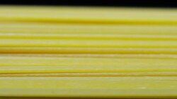 in the morning a young boy touches the hand of a fresh pasta to dry put them to ensure a high quality Stock Footage