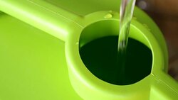 Filling clean water into green gallon. Stock Footage