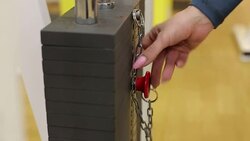 Closeup girl changing the bar with the weight on the simulator. Gym equipment. Stock Footage