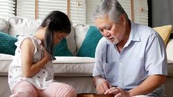Senior man and little girl playing board game together at home. people with family, lifestyle, education concept. 4k resolution. Stock Footage