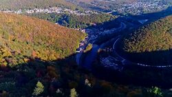 The top view on the road in the mountain's forest in Appalachian, Poconos, Pennsylvania, with fall foliage. Aerial drone video. Stock Footage