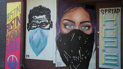 Passersby check out virus-themed murals in Texas Instructional Video