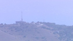 Wide shot of a Signal tower upon a hilltop News Clip