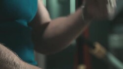 Strong man in gym sitting and gesturing while talking Stock Footage