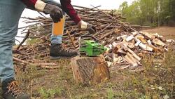 Lumberjack fixing / maintain the chainsaw outdoors. Stock Footage