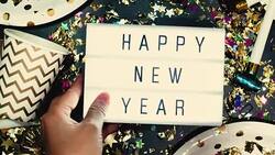 Close up hand lying down light box happy new year on party item on table Stock Footage