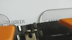 Close up shot of a person writing DISCRIMINATION on an old typewriter, with sound... Stock Footage