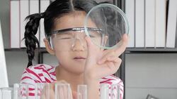 Education Topics:Funny little girl doing experiments in the laboratory.Science and education. Stock Footage