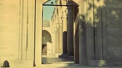 WIDE ANGLE OF INTERIOR STONE COURTYARD. PILLARS OR COLUMNS. STRIPED POINTED ARCHES. ISLAMIC ARCHITECTURE. SULEYMANIYE MOSQUE. DOME VISIBLE IN BG. POV THROUGH ENTRANCE. Stock Footage