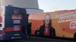 Campaign coincidence: Tory and Lib Dem bus park side by side at service station News Clip