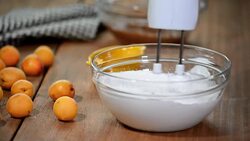 Female hands whipping egg whites cream in glass bowl with mixer. Stock Footage